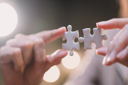 Close-up of business hands connecting jigsaw puzzle, success and goal achievement, the last jigsaw is the link of all the pieces. strategic planning or a solution for the management.の写真素材