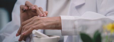 A young researcher is applying powdered research into his hands in the lab. women are happy to test...