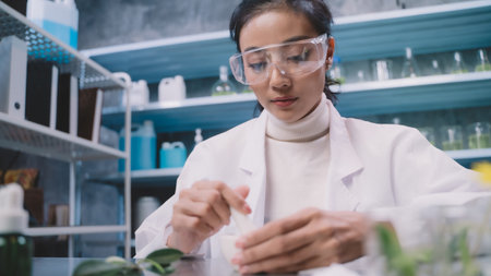 Young researcher is grind the powdered research into grinding cup in the laboratory. women are happy to test cosmetics or medicine for beautiful skin care.の写真素材