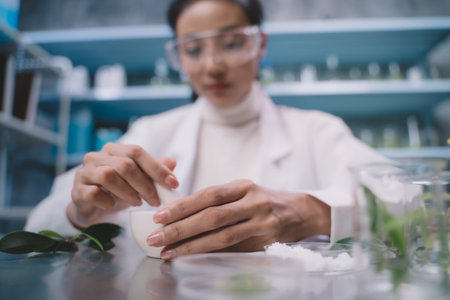 Young researcher is grind the powdered research into grinding cup in the laboratory. women are happy...