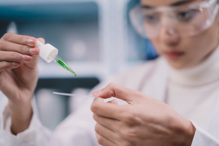 Two researcher are drop and looking at liquid to plate in their hands at laboratory.の写真素材