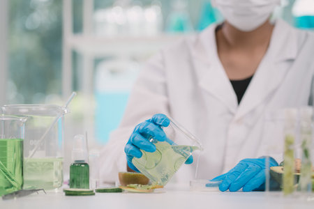 liquid substance was pouring into Petri tray by scientist or chemist in science experiment at cosmetic laboratory .の写真素材