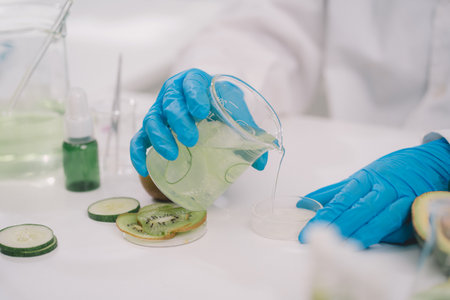 liquid substance was pouring into Petri tray by scientist or chemist in science experiment at cosmetic laboratory .の写真素材