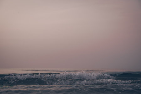 the wave in the beach before sunrise and the vanilla clearly sky, the landscape photo of the beautiful lonely beach on the dawn with no people and cloud.の写真素材