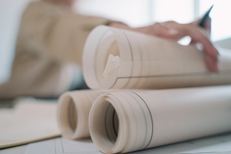 The architect carefully crafted the blueprint, transforming the detailed plan into a precise drawing for the ambitious project ahead.の写真素材