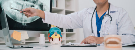 At the clinic, the dentist used an x-ray to examine the patientâs teeth, discussing treatment options and emphasizing the importance of oral health care and effective medicine.の写真素材