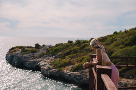 The woman enjoyed a solo travel vacation, basking in the summer sun, surrounded by nature, and embracing the freedom of a peaceful holiday getaway.の写真素材