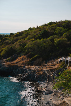 The island's beach glowed under the summer sky, where ocean waves met the shore; a perfect blend of sea, water, and nature, calling every soul to travel and explore.の写真素材