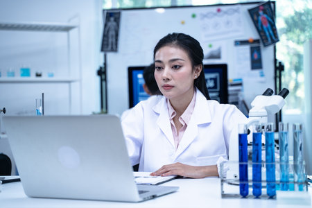 Scientist in laboratory conducting medical research using modern science and technology while taking note for doctor and clinical analysis.の写真素材