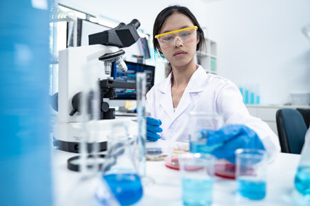 In the laboratory, several researchers and scientists, each focused on their own biology...