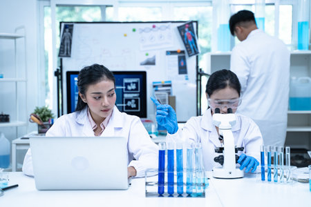 In the laboratory, several researchers and scientists, each focused on their own biology experiments, conduct detailed analysis to advance the field of science and deepen understanding.の写真素材