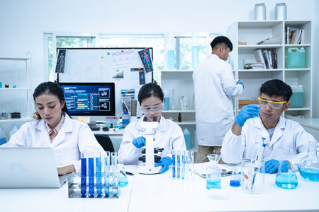 In the laboratory, several researchers and scientists, each focused on their own biology experiments, conduct detailed analysis to advance the field of science and deepen understanding.の写真素材