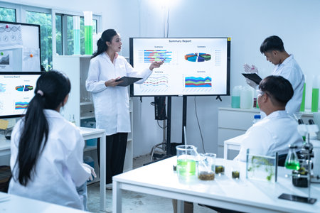 In the laboratory, a group of researchers meets to report their findings, discussing their work and preparing for future experiments, all focused on advancing science and health care.の写真素材