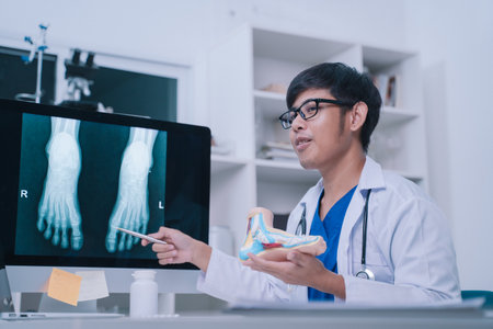 During the exam, the doctor used a model to explain the anatomy of the human foot and ankle to the...