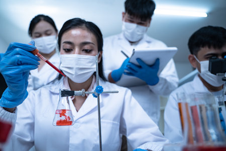 Laboratory research with blood sample in tube being dripped for medical test using liquid medicine...