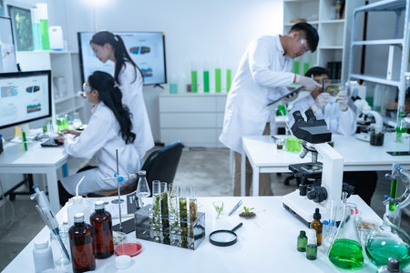 In the laboratory, a biologist uses advanced technology and computer analysis to compare data from...