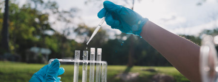 banner background is dropper releases each drop of liquid water during a research experiment, as...