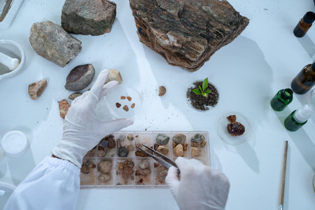 In the laboratory, research equipment rests on the table as scientists analyze rock samples, using...