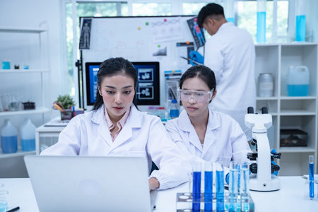 In the laboratory, several researchers and scientists, each focused on their own biology...
