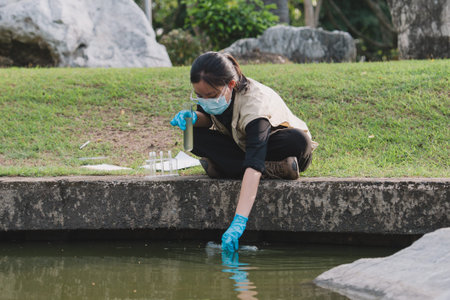 Science supports conservation as researchers study nature in the field, testing water and other liquid samples through analysis to better protect ecology and the environment.の写真素材