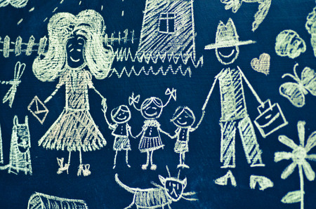 Drawing with chalk on blackboard large family of five peopleの写真素材