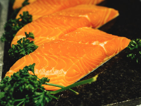 Raw salmon filet on black marble background
