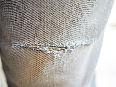 Close up of broken jeans