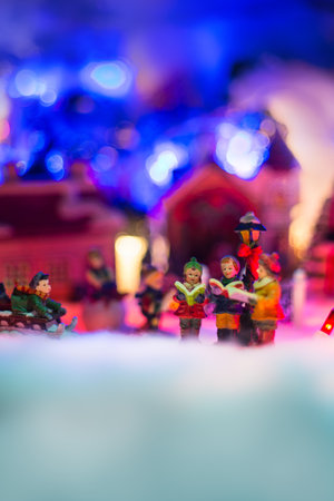 kids reading bible and playing sled in snowy christmas scenery. Holiday miniature landscape conceptの写真素材