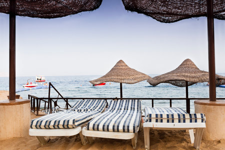 View of the sea framed by two parasolsの写真素材