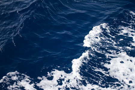 A single wave crashing in tropical blue waterの写真素材