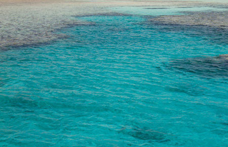 Tropical clear blue water surrounded by coralsの写真素材