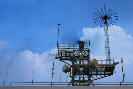 Radar tower at industrial harbor in evening sky