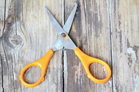 Yellow scissors on old wood