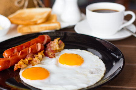 Breakfast with bacon, fried egg and orange juice are beneficial to health.の写真素材