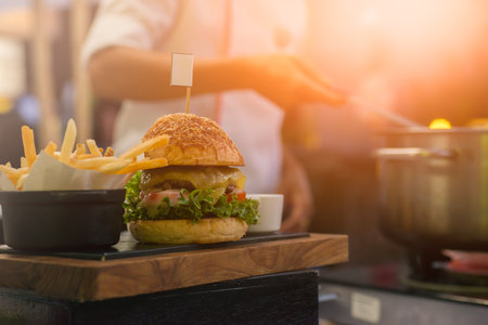 The chef is fried French fries and has a hamburger dishの写真素材