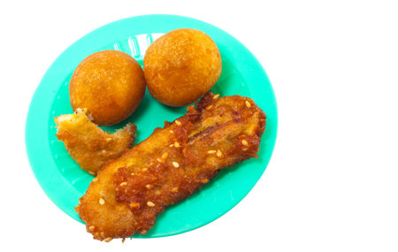 Brown Fried Bananas and deep-fried sweet potato balls on green dish