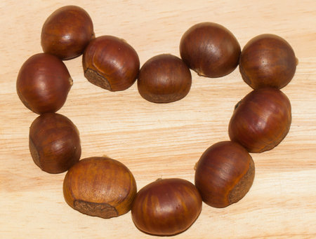Heart shape chestnut on the woodenの写真素材