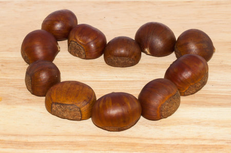 Fresh heart shape chestnut on the woodenの写真素材