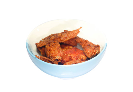 Closeup of fried chicken wings on the white and blue bowlの写真素材