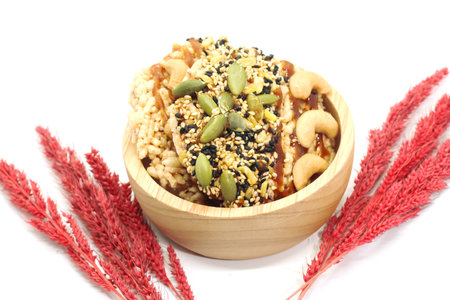 Closeup of two Sweet Crispy Rice Cracker with several cereal on wood cup and dry grassの写真素材