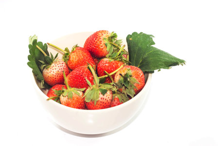 Macro of fresh Red Strawberry in the bowl on white backgroundの写真素材