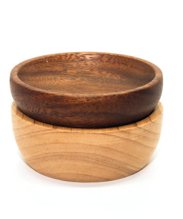 Closeup of two brown wooden cup on white backgroundの写真素材