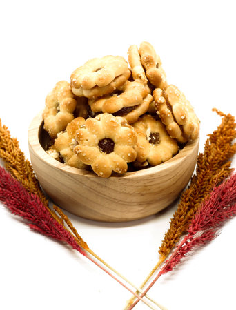 Closeup of cracker with pineapple jam on wooden cup and dry grassの写真素材