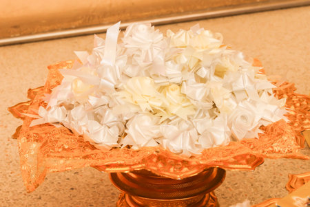 Closeup of alms flowers (Ribbon flowers),Thai culture on the golden trayの写真素材