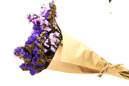 Close-up of brown bouquet purple statice dry flower on white backgroundの写真素材