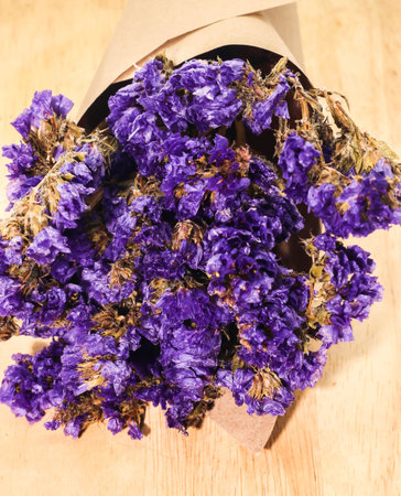 Close up of bouquet violet statice dry flower on white background