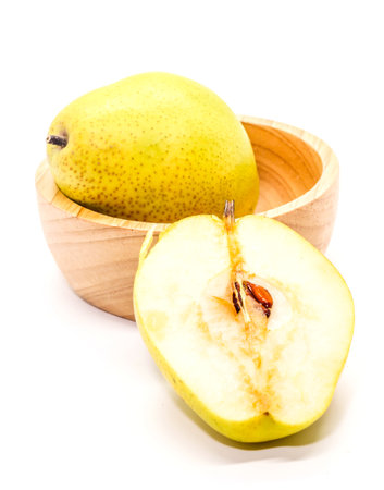 Closeup of yellow Fresh ripe organic pears on brown wooden cup and half pearの写真素材