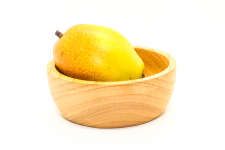Closeup of yellow Fresh ripe organic pears on wooden cupの写真素材