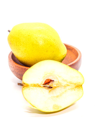 Macro yellow Fresh ripe organic pears on brown wooden cup and half pearの写真素材