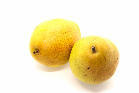 Two yellow Fresh ripe organic pears on white backgroundの写真素材